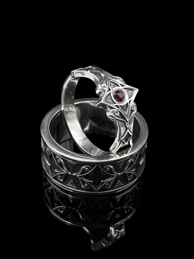A detailed macro shot of a sterling silver engagement ring. The focal point is a round, honey-colored gemstone (Citrine or Madeira Topaz) set flush into the band. The shank is decorated with a continuous relief pattern of spirals and circles, mimicking the decorative robes found in Gustav Klimt's "Golden Phase" paintings. The silver features an oxidized finish, creating a dark background that makes the polished spirals pop. (etsy image id: 7444385538)