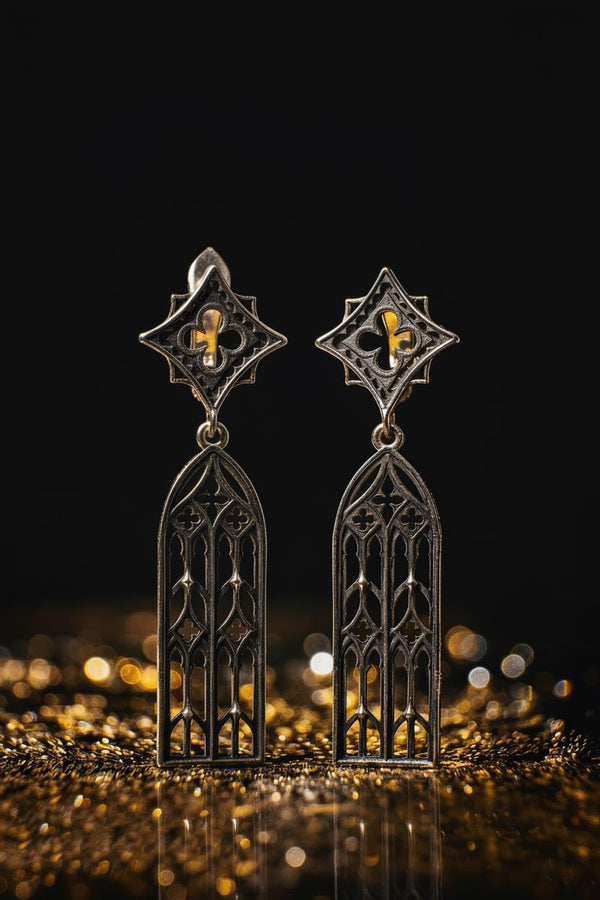 The image focuses on the interplay of light and shadow on the 925 sterling silver. The ridges of the arches are polished to a high shine, while the inner recesses are blackened with oxidation. This technique gives the earrings the visual weight of stone masonry while maintaining the lightness required for a comfortable ear dangle. (etsy image id: 7218591328)