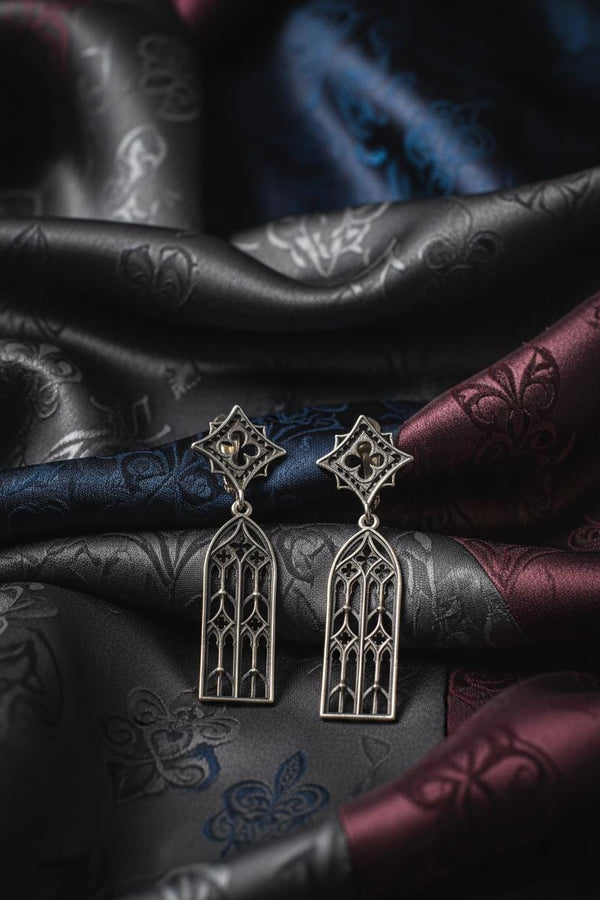 The image focuses on the interplay of light and shadow on the 925 sterling silver. The ridges of the arches are polished to a high shine, while the inner recesses are blackened with oxidation. This technique gives the earrings the visual weight of stone masonry while maintaining the lightness required for a comfortable ear dangle. (etsy image id: 7218591328)