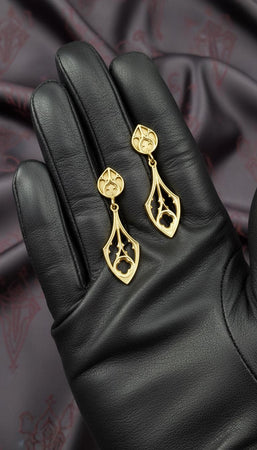 The Teardrop earrings are reimagined in 14k Yellow Gold. The transformation gives them the appearance of golden reliquaries or Byzantine treasures. The warm metal makes the tracery look like sunlit stained glass frames. This version feels opulent and holy, perfect for a wearer who wants to channel the grandeur of a royal court. (etsy image id: 7218813534)