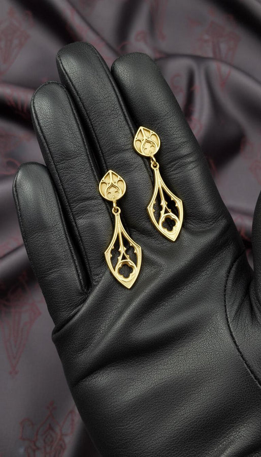 Embrace the dark appeal of gothic fashion with our Sterling Gothic Earrings. Each pair is exquisitely crafted in a gothic style, bringing a touch of mystery and romance to your look. An ideal choice for those who appreciate dark shades of elegance. The image highlights the high-contrast finish of the 925 sterling silver. The "relief" casting gives the tracery lines a three-dimensional quality, mimicking carved stone. (etsy image id: 6150699379)