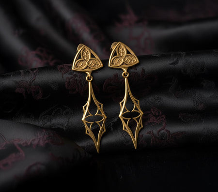 The Trefoil earrings are reimagined in 14k Yellow Gold. The transformation makes them look like a sacred reliquary or a golden amulet from a fantasy RPG. The warm metal emphasizes the solar aspect of the trinity knot. This version feels holy and radiant, perfect for a high-priestess look or a luxury gift for a history lover. (etsy image id: 7218874548)