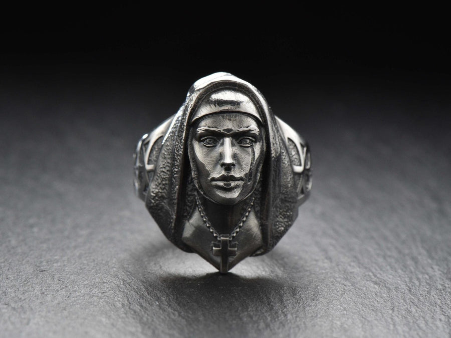 Crafted with meticulous attention to detail, this ring features a beautifully sculpted nun figure with a serene expression. The delicate design showcases the flowing robes and the distinct features that represent the dedicated life of a nun.
