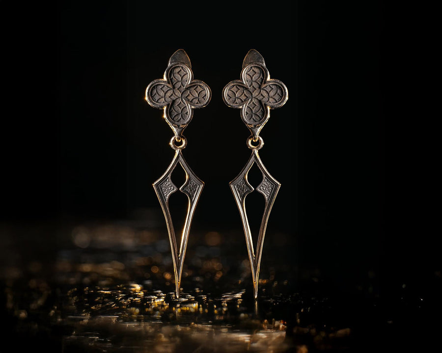 With their timeless beauty and one-of-a-kind design, these earrings are a must-have accessory for anyone who wants to stand out from the crowd. Don't miss this opportunity to own a piece of gothic elegance, order now! The image highlights the contrast between the two sections. The stud features a dense, "micro-relief" pattern that looks like chainmail or textile. The drop is smooth and linear, providing a visual break. (etsy image id: 7090850125)