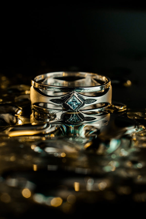 Mysterious and enchanting, this gothic silver ring is handcrafted with delicate detailing and a gemstone that adds a striking contrast to its intricate design.
A dramatic sterling silver ring with a central square blue gem, surrounded by carved details reminiscent of gothic architecture. Ideal for wearers seeking distinctive jewelry that stands apart from classic designs. (etsy image id: 7283442213)