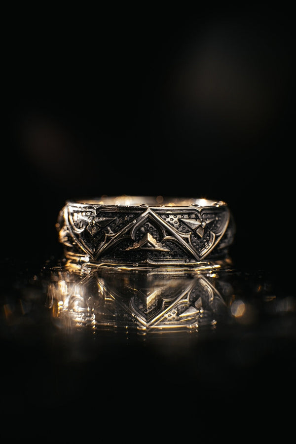 Detailed view of the ring's texture, showing the stippled, hammered finish inside the recessed arches. This "granulation" effect adds a raw, artisan quality to the piece, distinguishing it from mass-produced jewelry. The 925 sterling silver has been treated with sulfur to achieve a permanent dark patina in the low points, ensuring the architectural pattern remains visible even with daily wear. The metal looks solid and durable, suit (etsy image id: 7305774839)