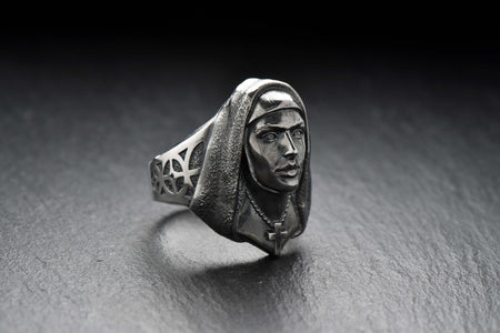 Crafted with meticulous attention to detail, this ring features a beautifully sculpted nun figure with a serene expression. The delicate design showcases the flowing robes and the distinct features that represent the dedicated life of a nun.