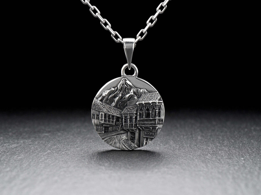 This beautiful pendant is the perfect souvenir to remember your trip to the beautiful city of Tbilisi. It features a detailed, hand-crafted design of the skyline of Tbilisi, Georgia.