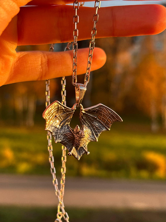 Featuring a detailed bat with outstretched wings, our unique design is sure to stand out. Don't let the darkness keep you down—power up your style with a silver bat pendant today! (etsy image id: 6086867201)