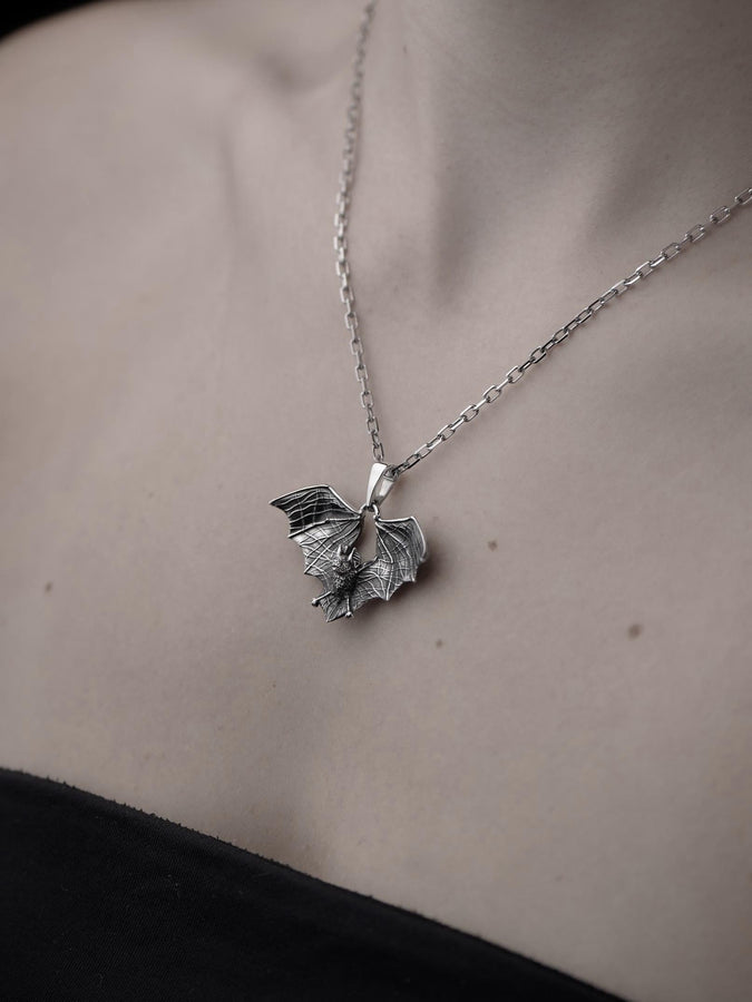 Featuring a detailed bat with outstretched wings, our unique design is sure to stand out. Don't let the darkness keep you down—power up your style with a silver bat pendant today! (etsy image id: 6086867201)