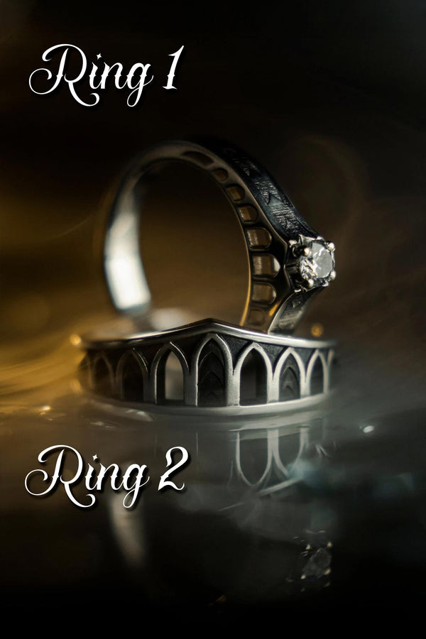 A professional studio photograph of a matching two-piece sterling silver wedding ring set. Both rings feature a prominent, raised Greek-style cross motif in the center, which holds a round, bezel-set white crystal. The interior of the cross arms has a fine, cross-hatched grid texture. Along the sides of the high-polished silver bands are recessed, four-lobed quatrefoil shapes. The rings are presented against a pitch-black background, making the p __etsy:8051335185
