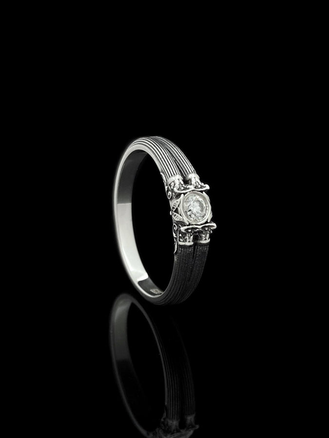 This sterling silver ring set features bold architectural column details with finely carved fluting and ornate capital motifs. The design draws inspiration from ancient Greek and Roman structures, offering a sculptural aesthetic that feels elegant and timeless. Ideal for wedding sets or collectors of detailed art jewelry, the polished silver contrasts beautifully with the deep engraved textures.