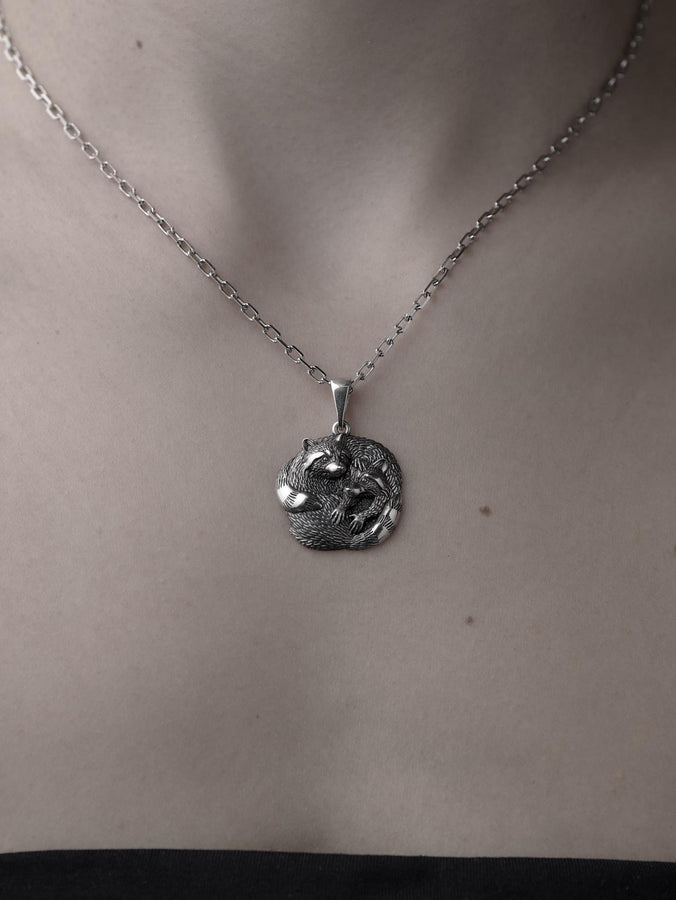 The pendant is made of high quality silver, which guarantees its durability and resistance to damage. Its unique adorable raccoon design is eye-catching and adds a pop of color to any look. (etsy image id: 6100406265)