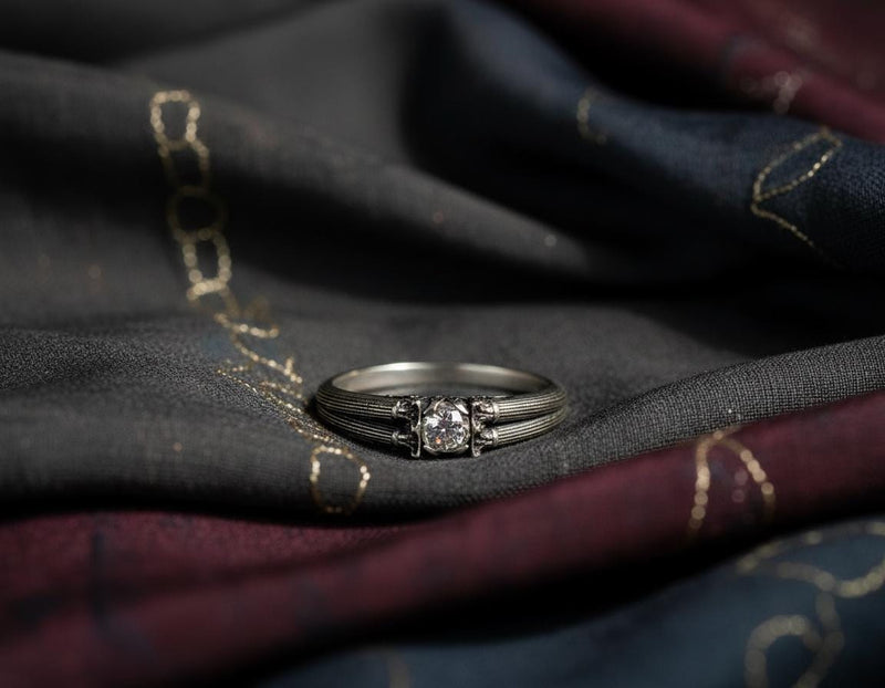 This sterling silver engagement ring features detailed Greek column motifs running around the band, inspired by ancient temples and classical architecture. Its Art Deco lines highlight symmetry and craftsmanship, while the raised stone setting adds elegance. Designed for lovers of historic aesthetics, it makes a striking proposal or anniversary gift. (etsy image id: 7417720808)