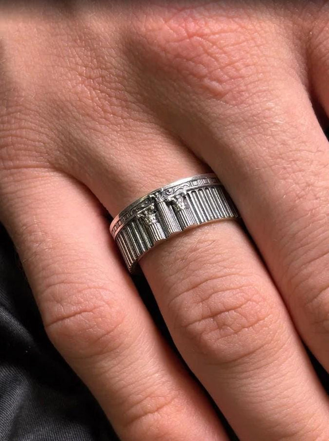 A handcrafted silver band ring with an ancient architectural theme. The carved columns and decorative patterns resemble historic Greek structures, giving the jewelry a symbolic and powerful presence. The design suits collectors of classical art, mythology enthusiasts and anyone who values bold and meaningful accessories. (etsy image id: 7417729506)