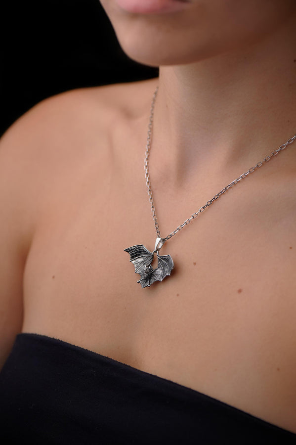 Featuring a detailed bat with outstretched wings, our unique design is sure to stand out. Don't let the darkness keep you down—power up your style with a silver bat pendant today! (etsy image id: 6086867201)