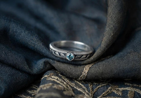 This sterling silver Art Nouveau wedding ring features detailed leaf engravings framed by a ridged outer border, creating a refined organic look. A round gemstone sits at the center, adding sparkle that highlights the botanical design. Perfect for nature lovers, the ring reflects hand-crafted artistry and vintage elegance, making it ideal for engagements, weddings, or meaningful anniversary gifts. (etsy image id: 7425561934)