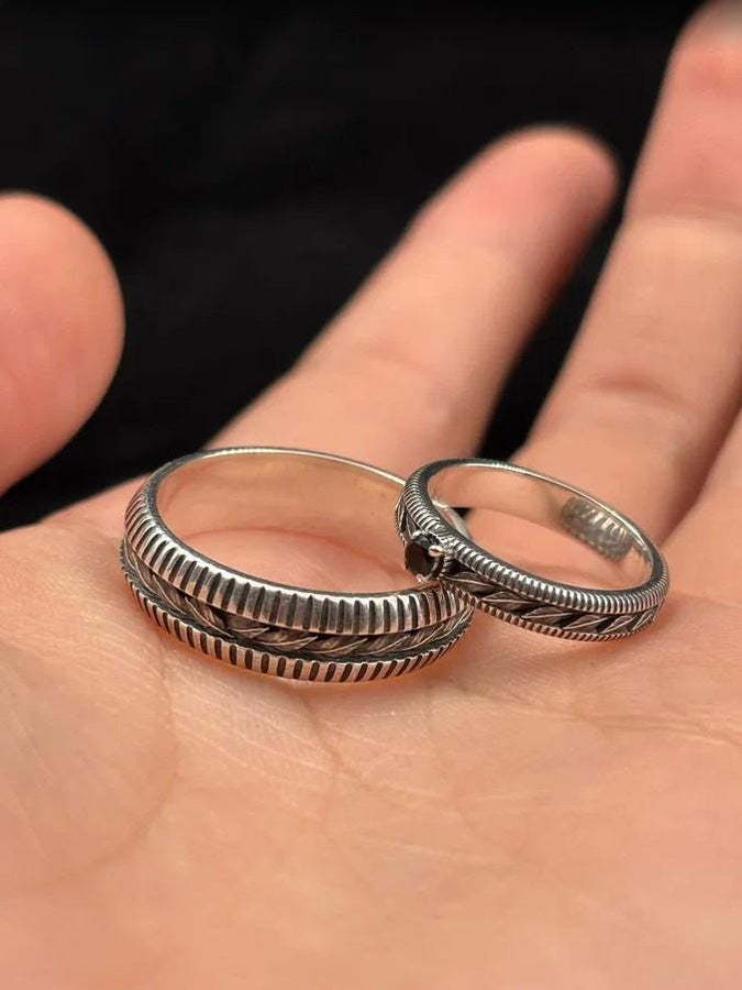 A nature-inspired silver wedding ring featuring raised leaf motifs and a shimmering round gemstone set in the center. The Art Nouveau style is expressed through smooth curves and organic detailing along the band. Ideal for brides or grooms who appreciate delicate plant symbolism, handcrafted jewelry, and an elegant blend of vintage and contemporary design elements in their wedding set. (etsy image id: 6300134508)