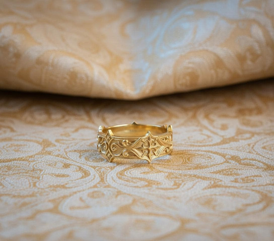 Handmade sterling silver band with an intricate gothic crown motif in the center, framed by swirling ornamental engravings. The deep relief and antique darkened finish evoke historic cathedral carvings. Ideal for customers seeking dark romantic jewelry, gothic accessories, medieval wedding rings, and meaningful silver bands with symbolic architecture-inspired designs. (etsy image id: 7423455351)