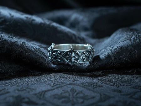 A detailed sterling silver gothic ring featuring a raised quatrefoil crown design surrounded by sculpted scrolls and medieval architectural lines. The oxidized texture highlights the dramatic depth of the metalwork, creating a dark romantic aesthetic. Ideal for customers searching for gothic jewelry, medieval rings, unique handmade bands, or symbolic gothic wedding pieces. (etsy image id: 7427203254)