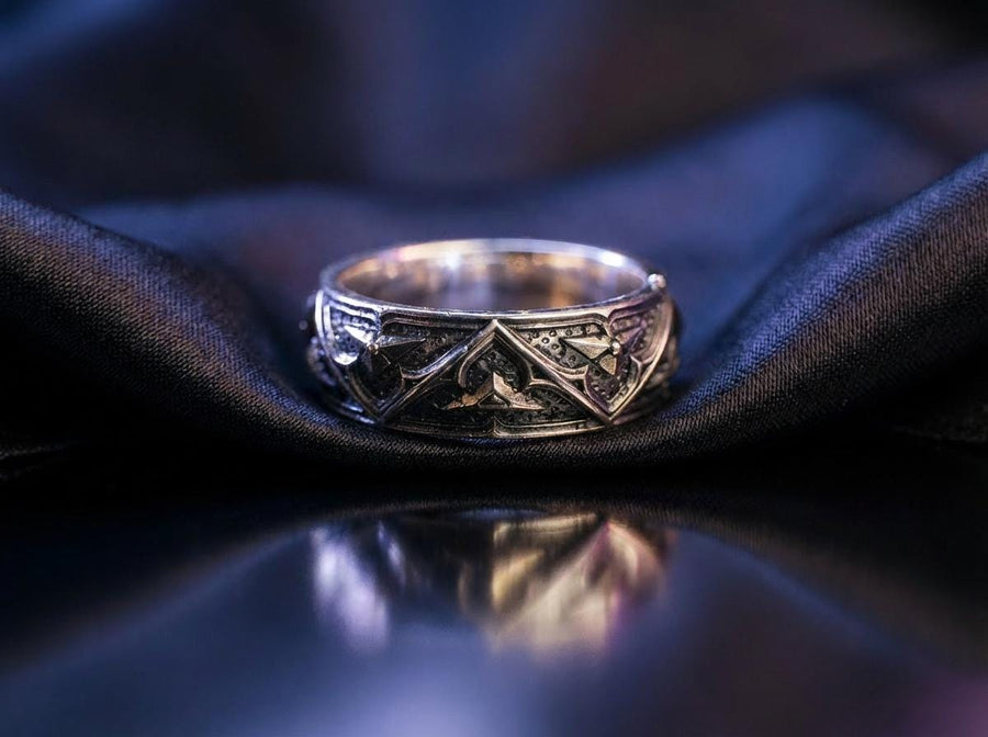 Detailed view of the ring's texture, showing the stippled, hammered finish inside the recessed arches. This "granulation" effect adds a raw, artisan quality to the piece, distinguishing it from mass-produced jewelry. The 925 sterling silver has been treated with sulfur to achieve a permanent dark patina in the low points, ensuring the architectural pattern remains visible even with daily wear. The metal looks solid and durable, suit (etsy image id: 7305774839)