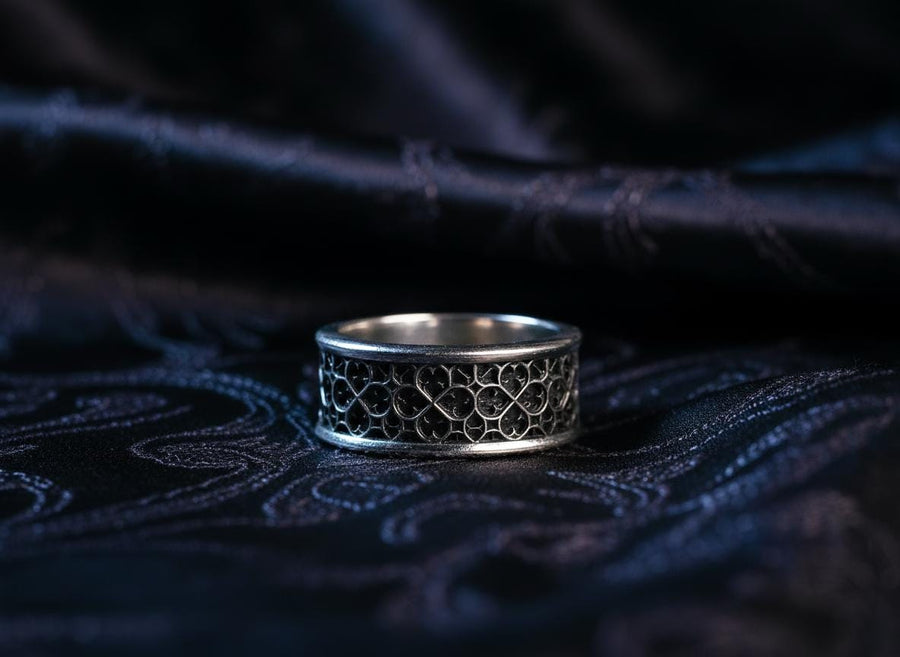This view focuses on the tactile quality of the 925 sterling silver. The raised lattice framework is smooth and rounded, ensuring it won't snag on clothing, while the black background has a stippled, grainy texture that absorbs light. The image captures the "chiaroscuro" effect of the metalwork—the interplay of light silver and dark shadow—which gives the ring a rugged, masculine feel suitable for daily wear. (etsy image id: 6052185804)