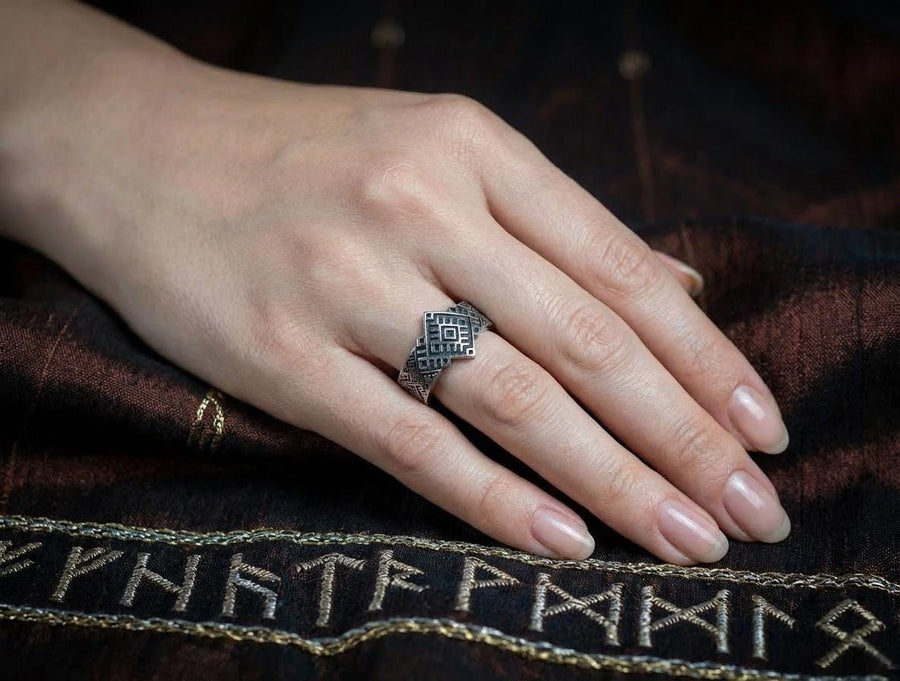 This close-up demonstrates the "relief" texture of the ring. The pattern is not merely etched but deeply cast, with significant height difference between the silver lines and the black background. The 925 sterling silver is substantial and thick. The oxidation is uniform and matte, designed to withstand daily wear without fading, creating a permanent "shadow" that defines the intricate geometry. (etsy image id: 7206997519)