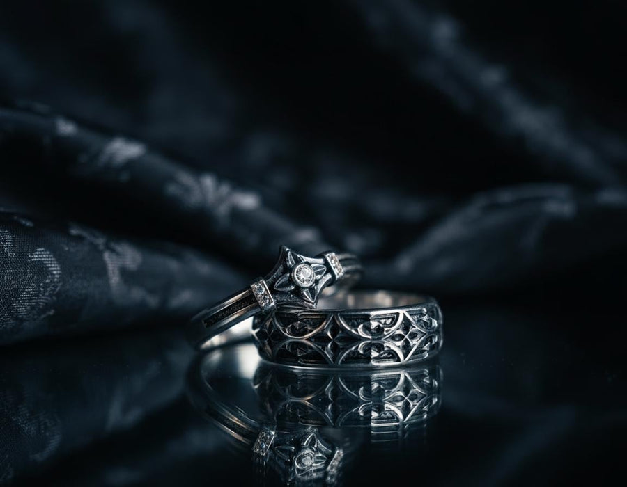 A macro photograph of a sterling silver ring with a distinct medieval silhouette. The centerpiece is a four-pointed "cross" or "star" shape holding a round, amber-hued gemstone (Citrine). The band is flanked by small, vertical bars set with tiny accent stones that sparkle in the light. The metal features a mix of high-polish highlights and dark, oxidized recesses, giving it an antique, artifact-like appearance. (etsy image id: 7488715953)