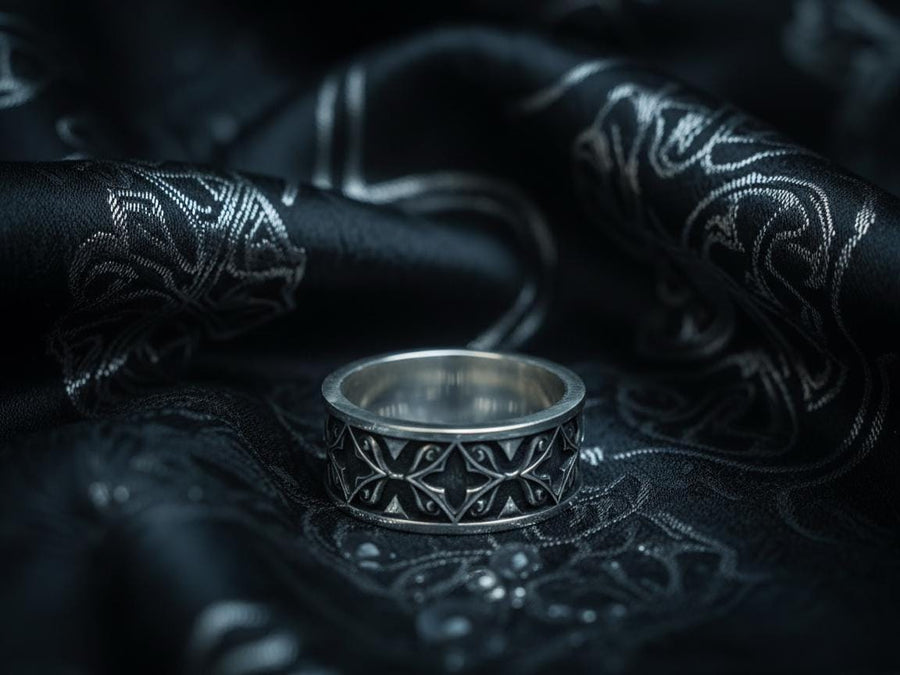 A detailed macro shot of a sterling silver engagement ring. The focal point is a round, honey-colored gemstone (Citrine or Madeira Topaz) set flush into the band. The shank is decorated with a continuous relief pattern of spirals and circles, mimicking the decorative robes found in Gustav Klimt's "Golden Phase" paintings. The silver features an oxidized finish, creating a dark background that makes the polished spirals pop. (etsy image id: 7444385538)