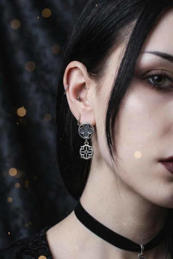 The image highlights the specific textures of the casting. The top stud has a "waffle" or lattice texture inside the quatrefoil lobes, mimicking chainmail or stone carving. The bottom drop is smooth and open, providing a visual counterweight. The 925 sterling silver is treated with an antique patina to enhance the "old world" feel. Modeled as a versatile daily earring, the "coin" size is modest enough for office wear (etsy image id: 5775868859)