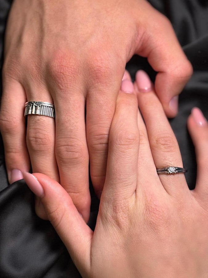 This sterling silver ring set features bold architectural column details with finely carved fluting and ornate capital motifs. The design draws inspiration from ancient Greek and Roman structures, offering a sculptural aesthetic that feels elegant and timeless. Ideal for wedding sets or collectors of detailed art jewelry, the polished silver contrasts beautifully with the deep engraved textures.