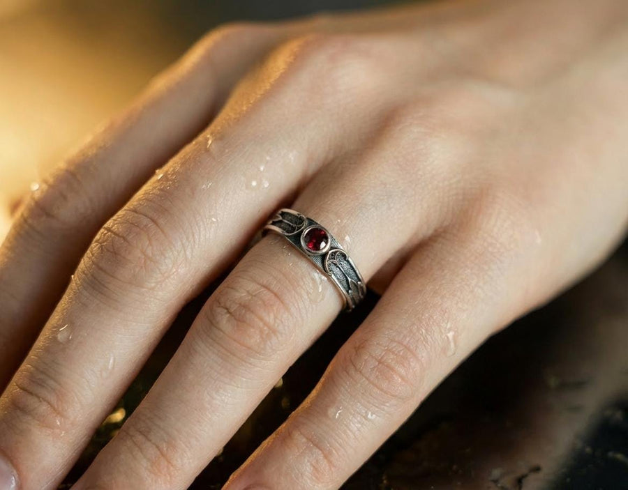 This gothic sterling silver ring features a vivid red garnet set in a detailed medieval-inspired band with darkened textures and graceful, pointed motifs. Designed for lovers of fantasy, gothic fashion, and artisan jewelry, it offers an elegant yet dramatic look. Perfect as a unique wedding band, engagement ring, or statement piece for anyone drawn to symbolic and timeless gothic style. (etsy image id: 7425901470)