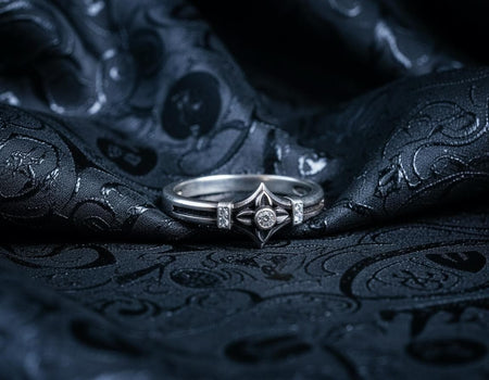 A macro photograph of a sterling silver ring with a distinct medieval silhouette. The centerpiece is a four-pointed "cross" or "star" shape holding a round, amber-hued gemstone (Citrine). The band is flanked by small, vertical bars set with tiny accent stones that sparkle in the light. The metal features a mix of high-polish highlights and dark, oxidized recesses, giving it an antique, artifact-like appearance. (etsy image id: 7488715953)