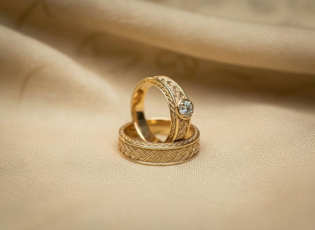 The set is reimagined in 14k Yellow Gold. The transformation gives the rings the appearance of ancient Celtic gold torcs or treasure hoard finds. The warm yellow metal enhances the "rope" detail, making it look like spun gold thread. This version exudes warmth and royalty, elevating the rustic woven design to a luxurious fine jewelry status suitable for a formal church wedding.