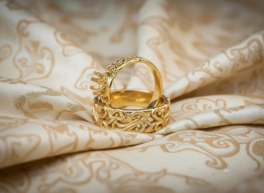 A high-contrast studio shot of a two-piece sterling silver ring set. The top ring features a raised, three-dimensional "crown" or "coronet" motif with small spheres on the tips. The bottom ring is a matching wide band. Both rings are covered in intricate, raised scrollwork or vine-like filigree. The silver is polished bright on the raised swirls, contrasting with the black oxidized background.