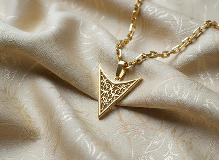 The Arrowhead pendant is reimagined in 14k Yellow Gold. The transformation makes it look like a "Royal Spear Tip" or a ceremonial artifact. The organic tracery inside looks like golden vines growing within a frame. This version feels luxurious and solar, radiating energy and power, perfect for a high-end fantasy jewelry collection. (etsy image id: 7496357629)