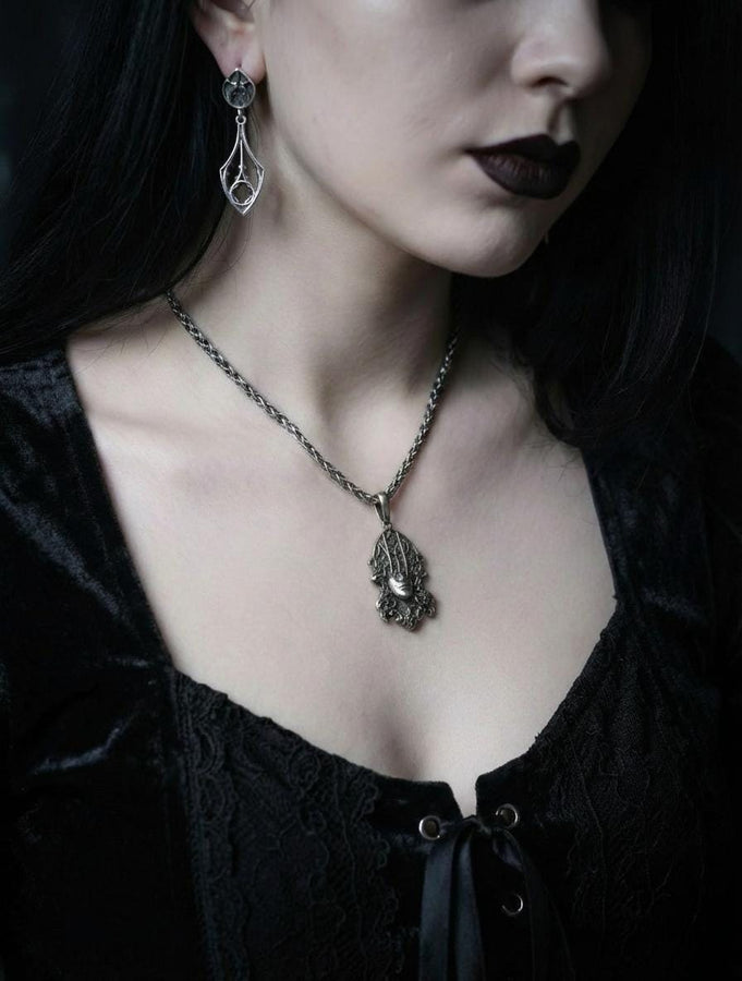Embrace the dark appeal of gothic fashion with our Sterling Gothic Earrings. Each pair is exquisitely crafted in a gothic style, bringing a touch of mystery and romance to your look. An ideal choice for those who appreciate dark shades of elegance. The image highlights the high-contrast finish of the 925 sterling silver. The "relief" casting gives the tracery lines a three-dimensional quality, mimicking carved stone. (etsy image id: 6150699379)
