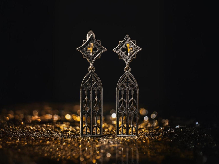 The image focuses on the interplay of light and shadow on the 925 sterling silver. The ridges of the arches are polished to a high shine, while the inner recesses are blackened with oxidation. This technique gives the earrings the visual weight of stone masonry while maintaining the lightness required for a comfortable ear dangle. (etsy image id: 7218591328)