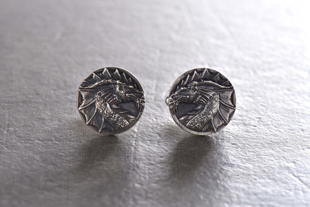 May include: A pair of silver cufflinks featuring a detailed dragon head design. (etsy image id: 7689558200)