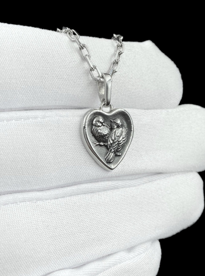 This silver titmouse heart pendant necklace captures tenderness, closeness, and quiet romance in a piece that feels deeply personal. The heart-shaped pendant with two titmice creates a meaningful design that symbolizes love, warmth, and connection. (etsy image id: 7963557331)