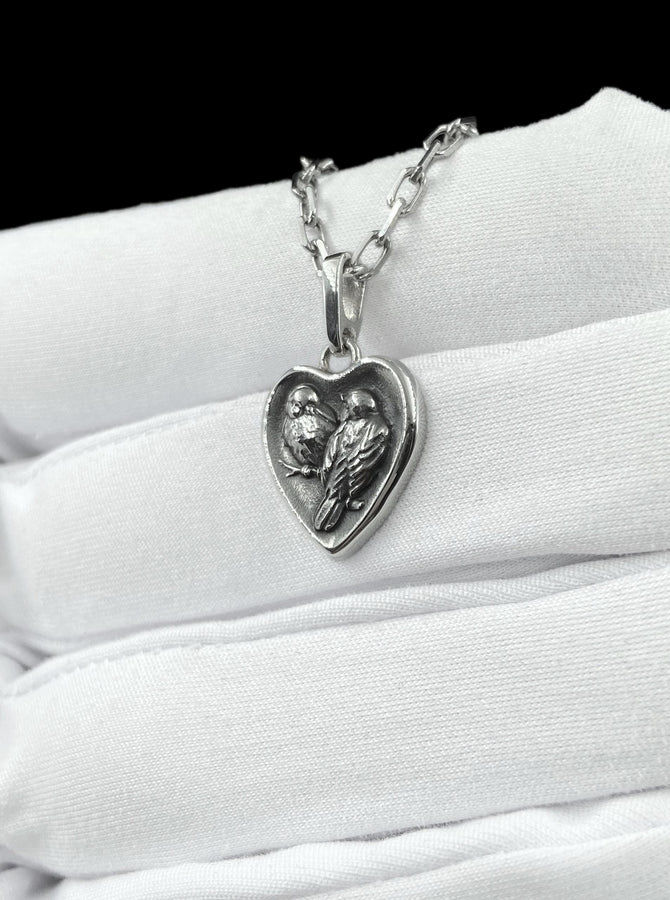 This silver titmouse heart pendant necklace captures tenderness, closeness, and quiet romance in a piece that feels deeply personal. The heart-shaped pendant with two titmice creates a meaningful design that symbolizes love, warmth, and connection. (etsy image id: 7963557331)