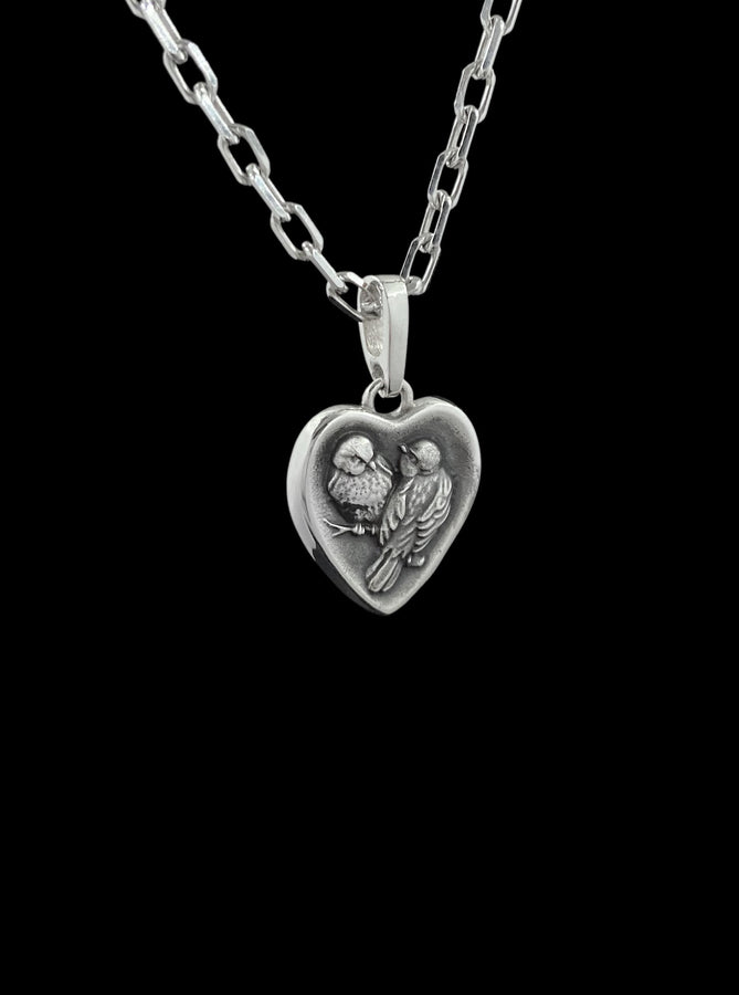 This silver titmouse heart pendant necklace captures tenderness, closeness, and quiet romance in a piece that feels deeply personal. The heart-shaped pendant with two titmice creates a meaningful design that symbolizes love, warmth, and connection. (etsy image id: 7963557331)