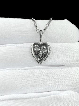 This silver titmouse heart pendant necklace captures tenderness, closeness, and quiet romance in a piece that feels deeply personal. The heart-shaped pendant with two titmice creates a meaningful design that symbolizes love, warmth, and connection. (etsy image id: 7963557331)