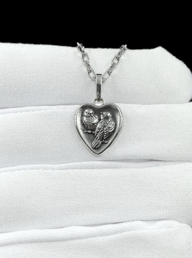 This silver titmouse heart pendant necklace captures tenderness, closeness, and quiet romance in a piece that feels deeply personal. The heart-shaped pendant with two titmice creates a meaningful design that symbolizes love, warmth, and connection. (etsy image id: 7963557331)