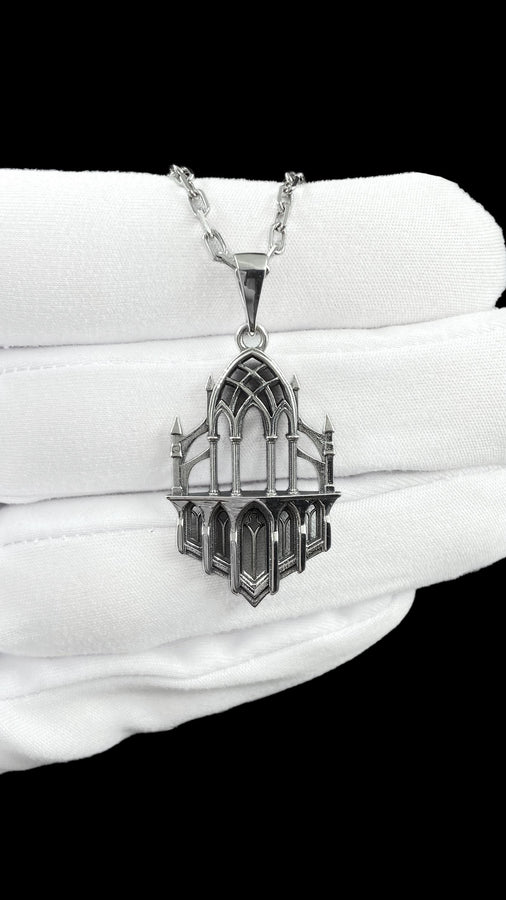 This macro image highlights the masterful craftsmanship of the solid 925 sterling silver casting. The artisan has flawlessly translated monumental stone architecture into miniature metalwork. The columns are smooth and precise, while deep sulfur oxidation creates a permanent matte black shadow in the open recesses of the arches. This traditional antiquing technique gives the gothic relic pendant the weathered, enduring texture of an actual historical cathedral fragment. (etsy image id: 7979026828)