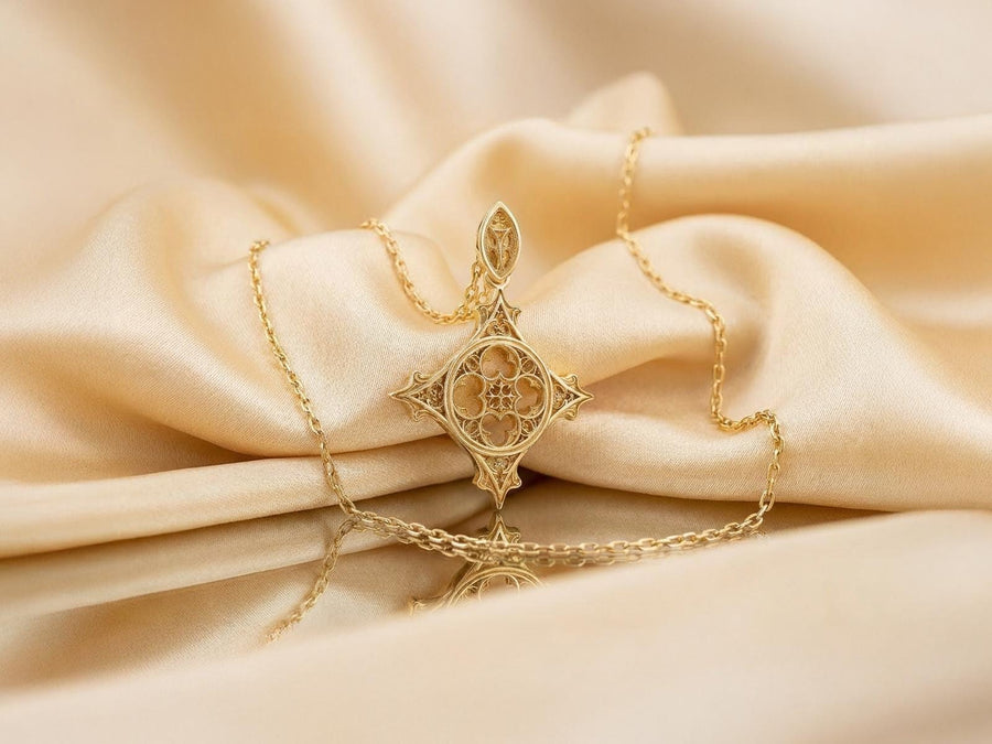 Showcasing exceptional openwork silversmithing, this gothic cross pendant demonstrates precise micro-casting techniques. The slender mullions and tracery lines are perfectly symmetrical and structurally sound, maintaining the airy lightness of a true cathedral window. A sturdy, intricately decorated silver bail is seamlessly integrated into the top point, ensuring the heavy charm hangs perfectly balanced on its chain. (etsy image id: 8027043505)