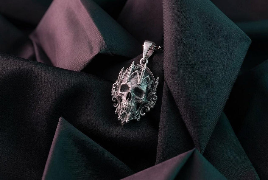 This macro image highlights the masterful texturing of the solid 925 sterling silver casting. The artisan has beautifully captured the smooth, anatomical curves of the organic skull, contrasting them against the rigid, geometric lines of the gothic tracery and cathedral spires. A deep sulfur patina treatment provides permanent matte black shadows, giving this wearable sculpture the rugged, weathered patina of a genuine historical artifact. (etsy image id: 7979410208)