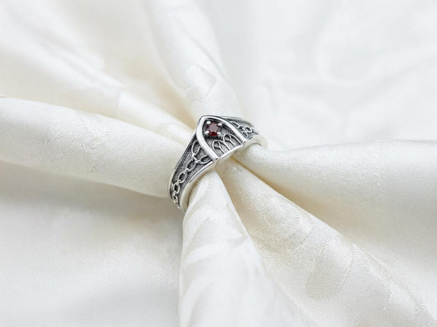 A professional studio photograph of a matching two-piece sterling silver wedding ring set. Both rings feature a prominent, raised Greek-style cross motif in the center, which holds a round, bezel-set white crystal. The interior of the cross arms has a fine, cross-hatched grid texture. Along the sides of the high-polished silver bands are recessed, four-lobed quatrefoil shapes. The rings are presented against a pitch-black background, making the p __etsy:8051335185