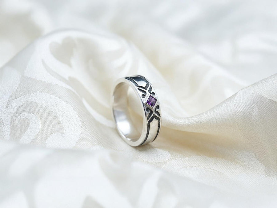 A professional studio photograph of a matching two-piece sterling silver wedding ring set. Both rings feature a prominent, raised Greek-style cross motif in the center, which holds a round, bezel-set white crystal. The interior of the cross arms has a fine, cross-hatched grid texture. Along the sides of the high-polished silver bands are recessed, four-lobed quatrefoil shapes. The rings are presented against a pitch-black background, making the p __etsy:8051335185