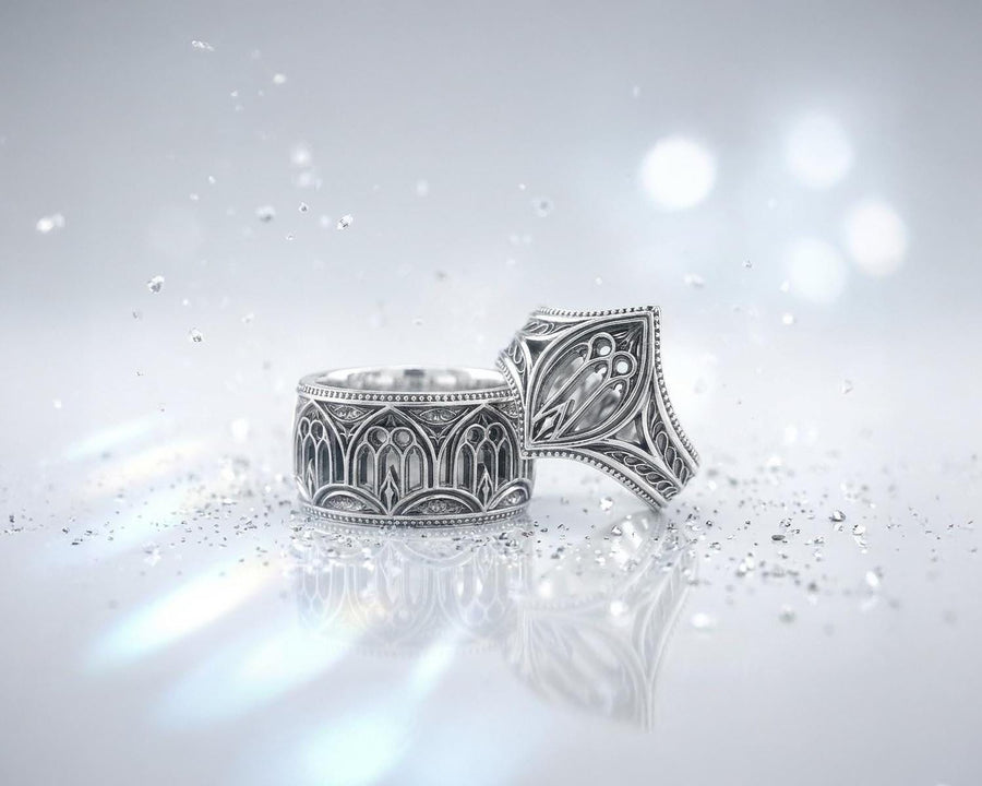 A high-resolution macro shot of a wide sterling silver wedding band resting on a sparkling, icy white surface. The ring features an intricate openwork design mimicking a Gothic cathedral window, complete with pointed lancet arches and delicate stone tracery. The polished silver highlights contrast beautifully against the dark, oxidized background, emphasizing the architectural depth of the piece.